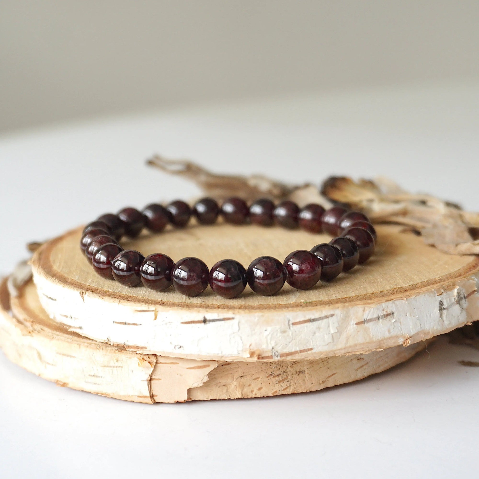 Garnet beaded bracelet made with natural 8mm garnet beads on a stretch cord, shown as a full view