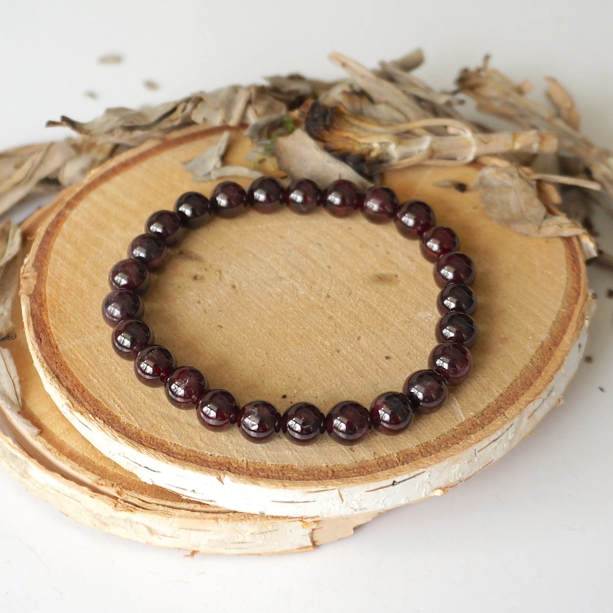 Bird’s-eye view of a garnet beaded bracelet showing evenly spaced 8mm garnet beads