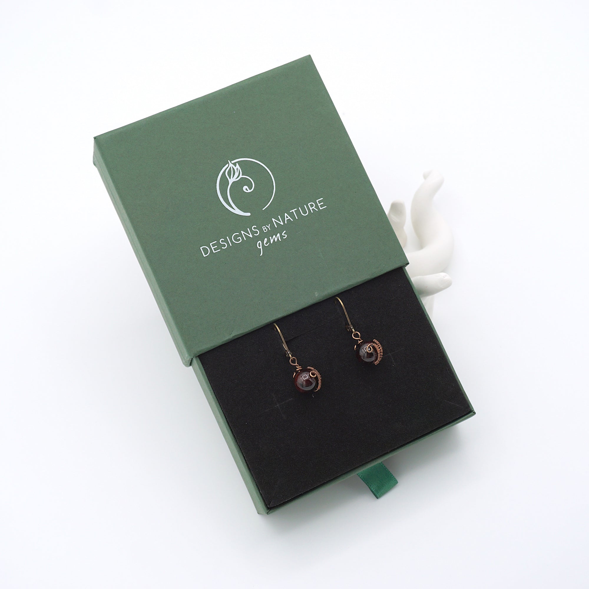 Garnet drop earrings presented in a branded gift box, ready for gifting, with antique bronze copper wire wrapping.