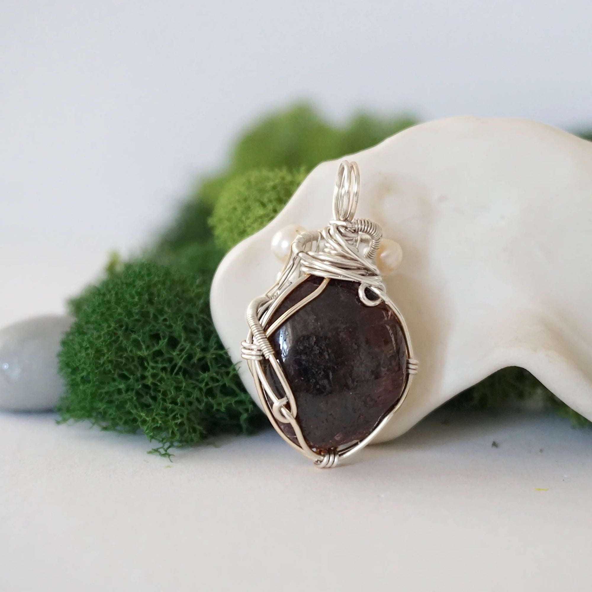 Back detail of silver wire wrapped garnet and freshwater pearl pendant necklace, handcrafted gemstone jewelry