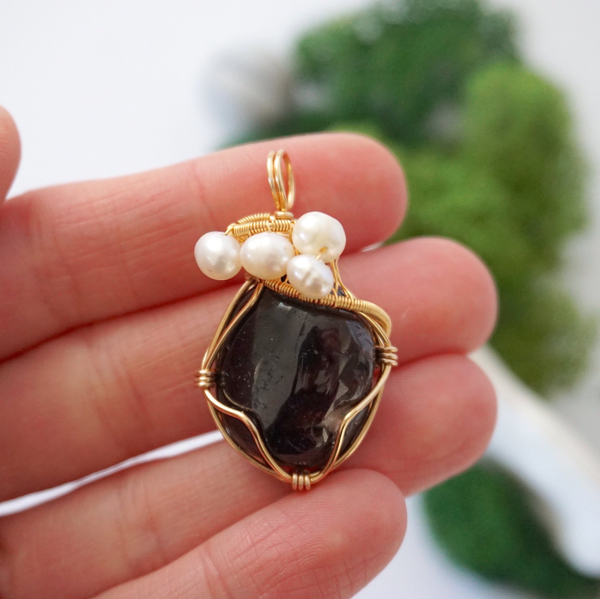 Garnet and freshwater pearl necklace pendant in hand for size reference, artisan birthstone jewelry gift for her