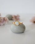 Detailed front view of minimalist gold aquamarine ring, natural 6mm aquamarine bead