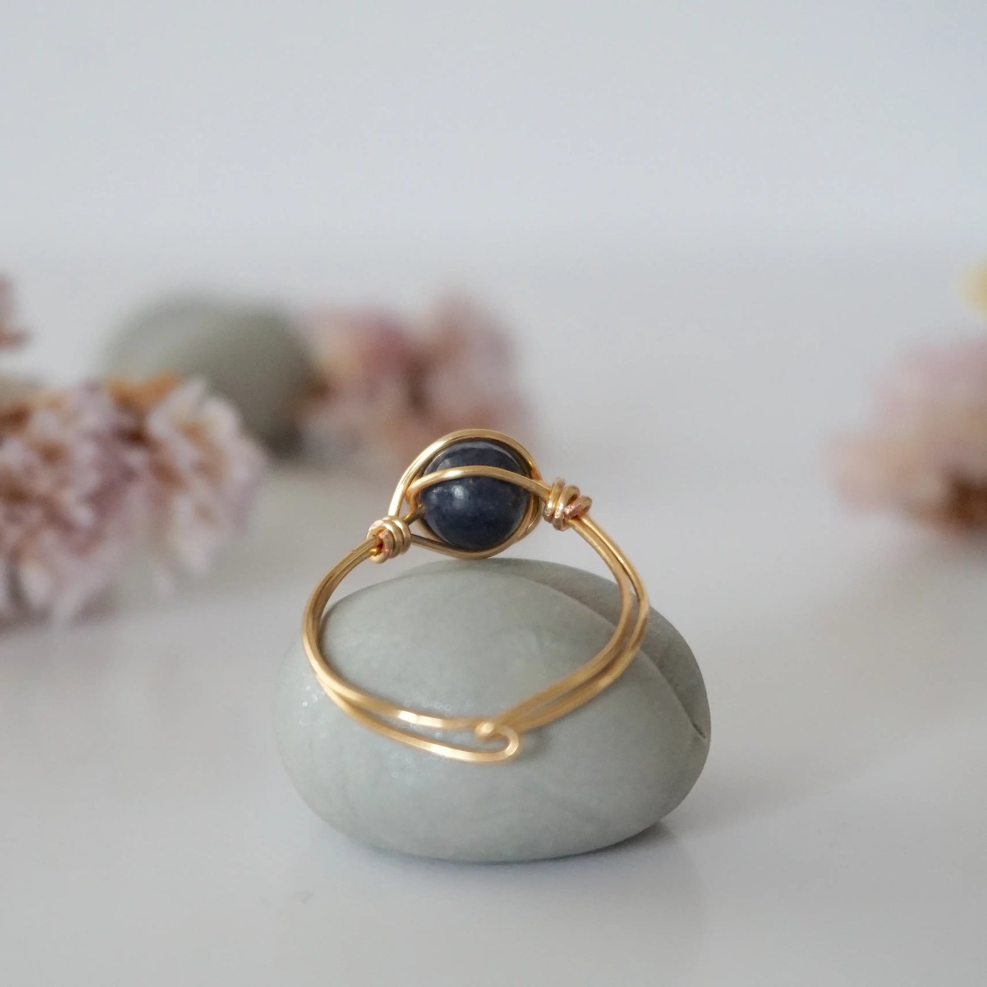 Back-angle view of gold sapphire ring revealing the handcrafted minimalist wire-wrapped band and artisan finish