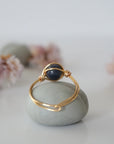 Back-angle view of gold sapphire ring revealing the handcrafted minimalist wire-wrapped band and artisan finish