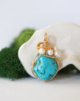 Detailed front view of gold wire wrapped turquoise and freshwater pearl pendant showing artisan craftsmanship