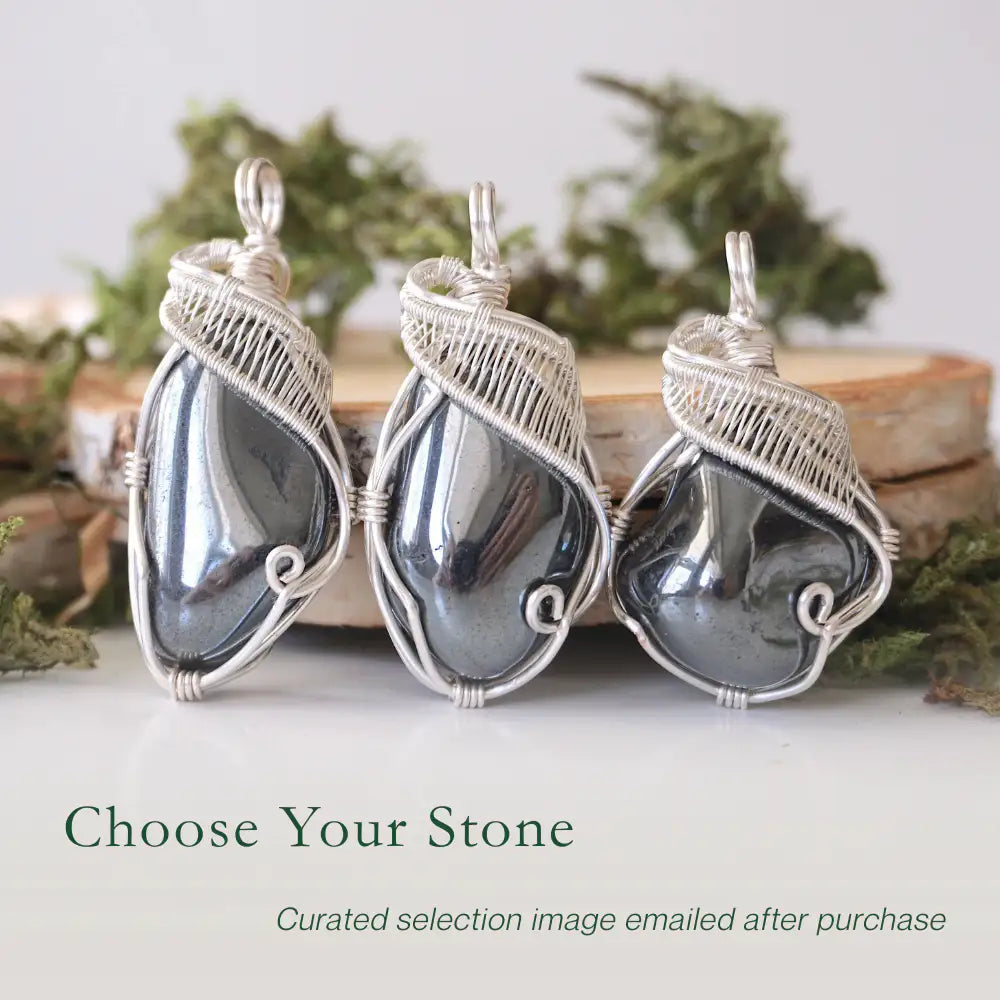 Three natural hematite pendants showing variation in size and shape in handmade wire wrapped jewelry