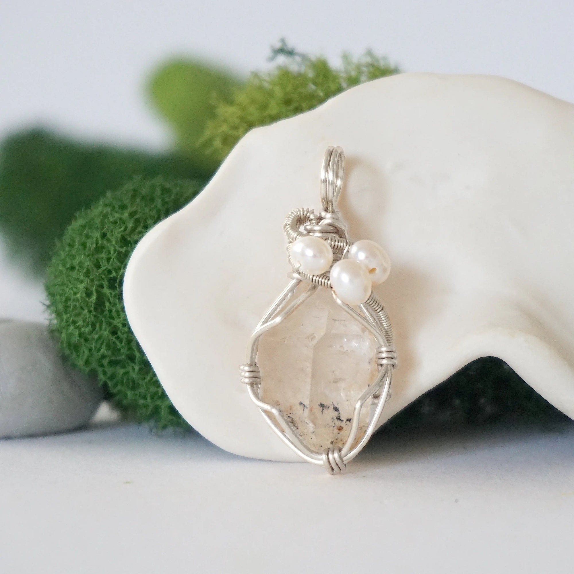 Detailed front view of silver wire wrapped herkimer diamond and freshwater pearl pendant, unique artisan necklace