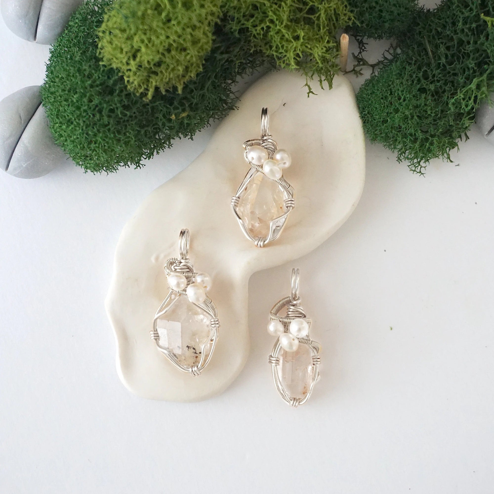 Three silver wire wrapped herkimer diamond and freshwater pearl pendants showing natural stone variation, artisan jewelry for women