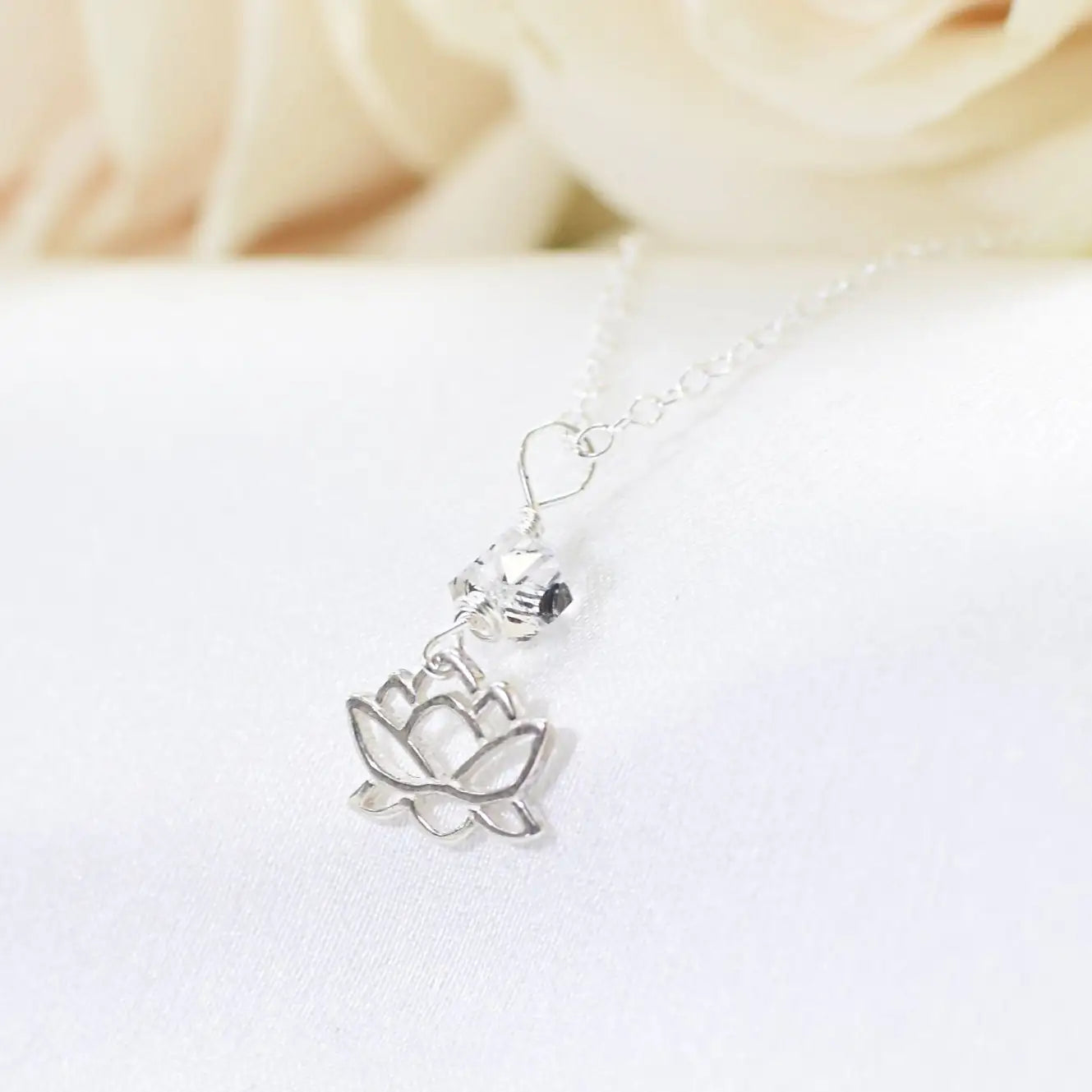 Angled detail of Herkimer diamond and lotus necklace showing handcrafted artisan design in 925 sterling silver.
