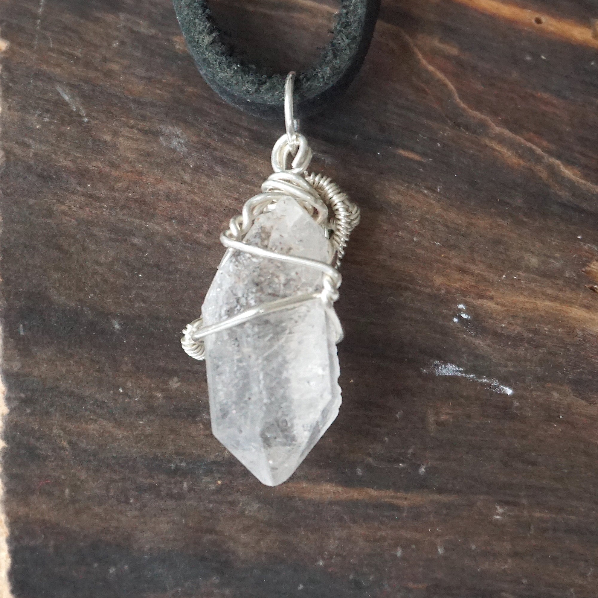 Back angle detail of raw Herkimer diamond pendant for men with intricate artisan wire wrapping in 925 sterling silver.