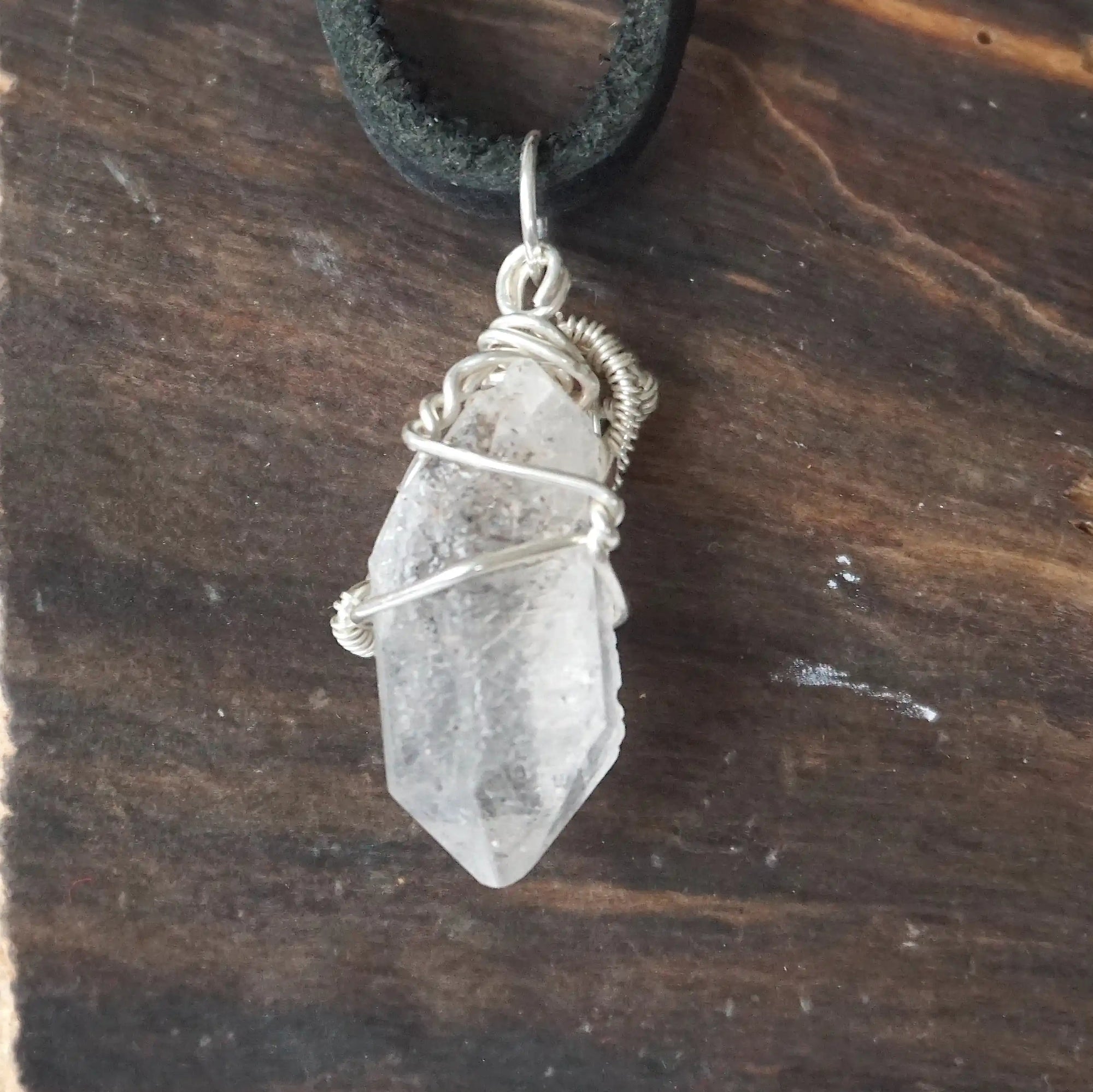 Back angle detail of raw Herkimer diamond pendant for men with intricate artisan wire wrapping in 925 sterling silver.