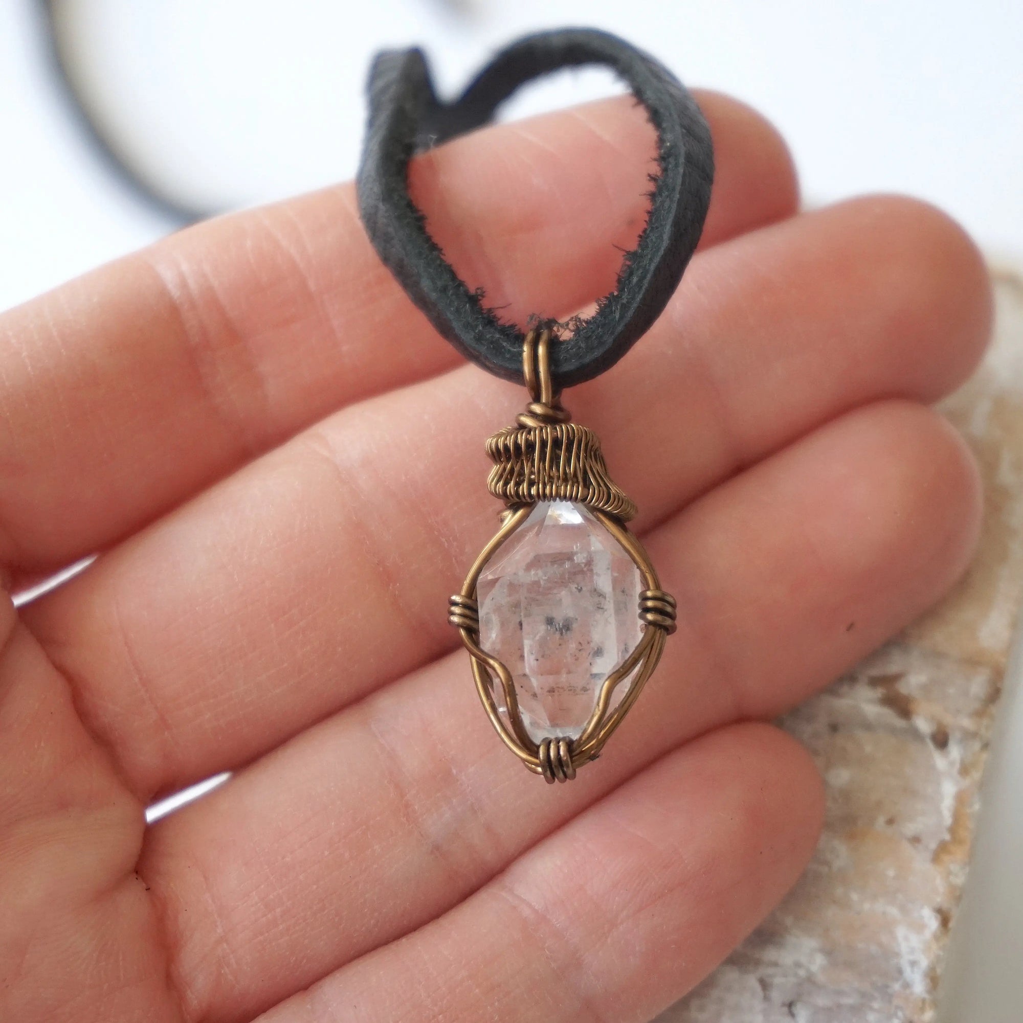 Raw Herkimer diamond pendant for men shown in hand for size reference, handmade in antique bronze copper.