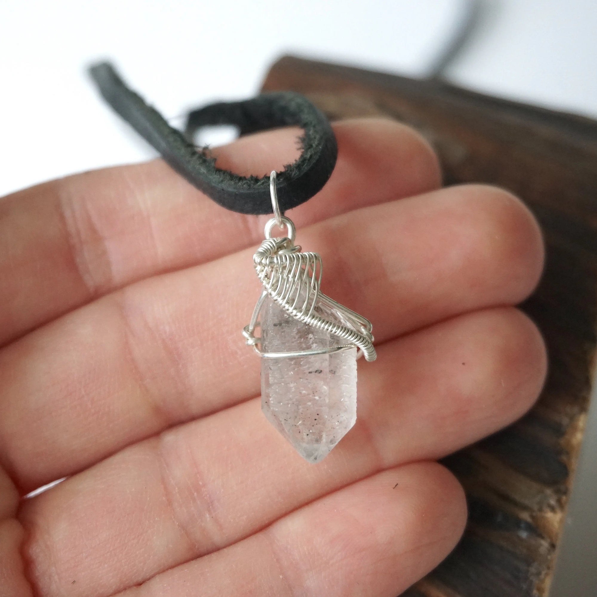 Raw Herkimer diamond pendant for men shown in hand for size reference, handmade in 925 sterling silver.