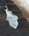 Right angle view of raw Herkimer diamond pendant for men showing detailed artisan wire wrapping in 925 sterling silver.