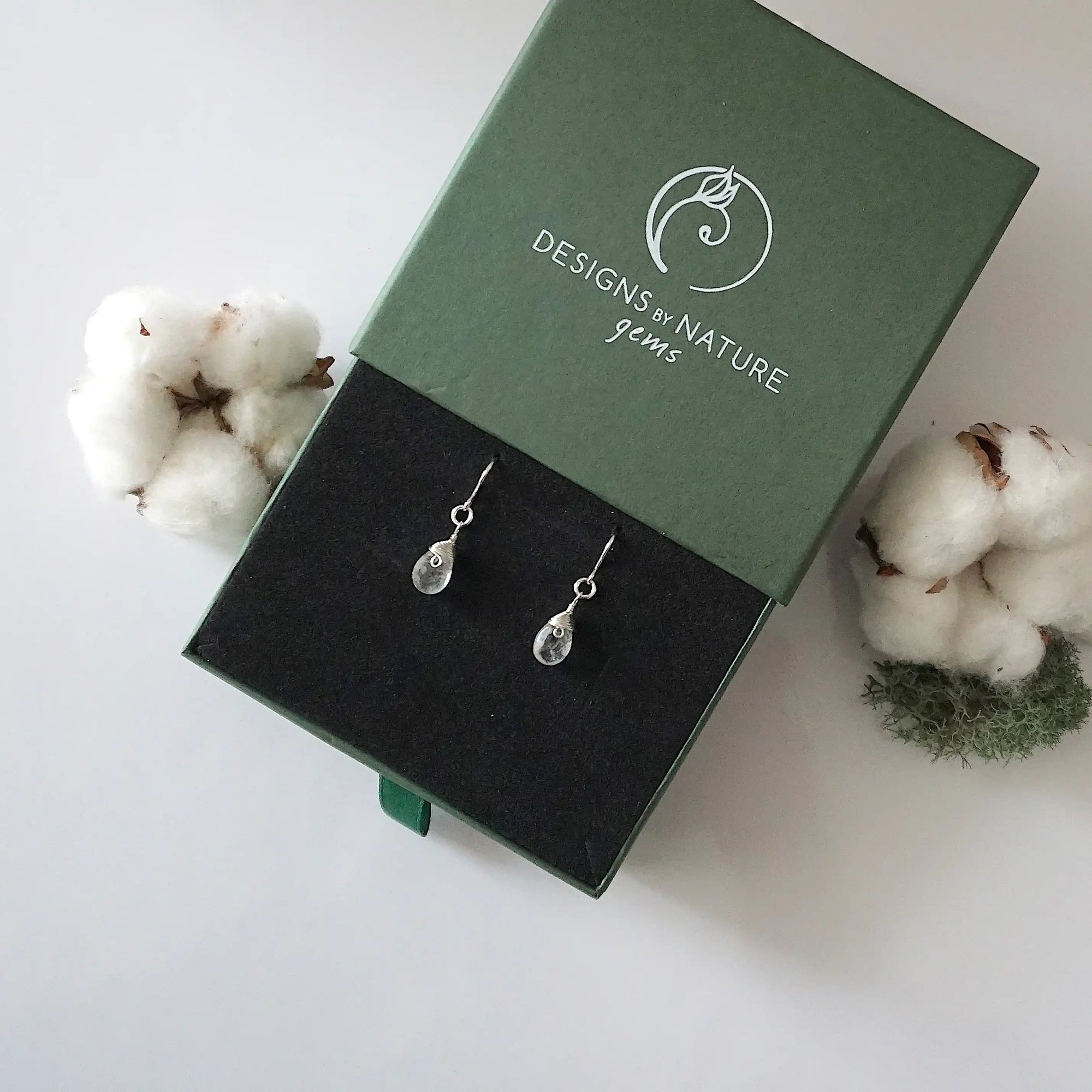 Herkimer diamond sterling silver drop earrings in branded Designs by Nature Gems jewelry box, showcasing handcrafted faceted Herkimer diamond and sterling silver wire wrapping