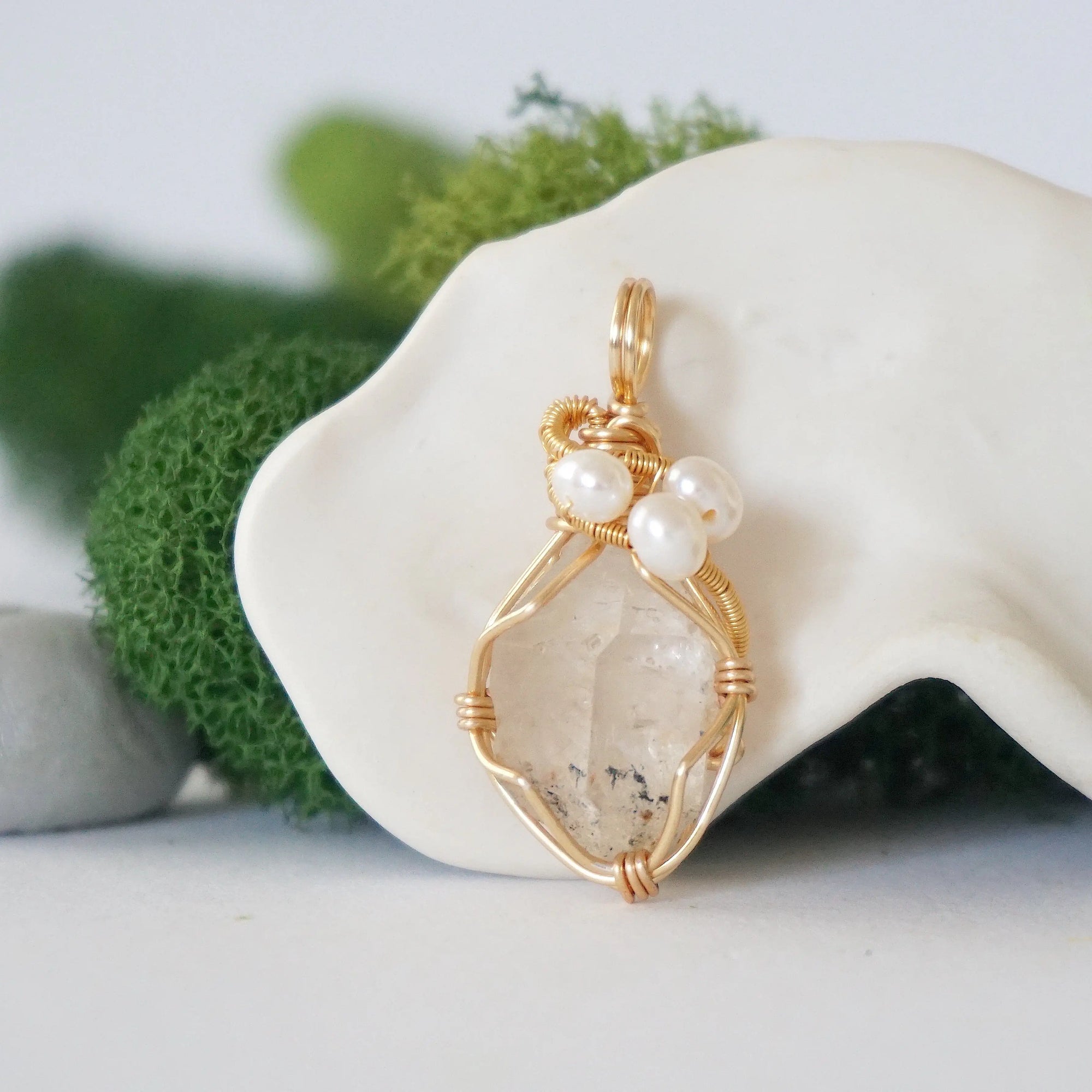 Detailed front angle of herkimer diamond and freshwater pearl pendant, gold wire wrapped, handcrafted gemstone jewelry
