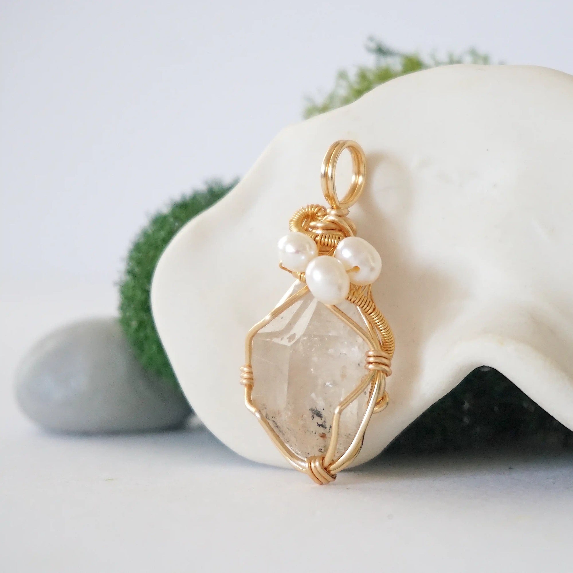 Side angle detail of herkimer diamond and freshwater pearl pendant, gold wire wrapped, ethical artisan necklace
