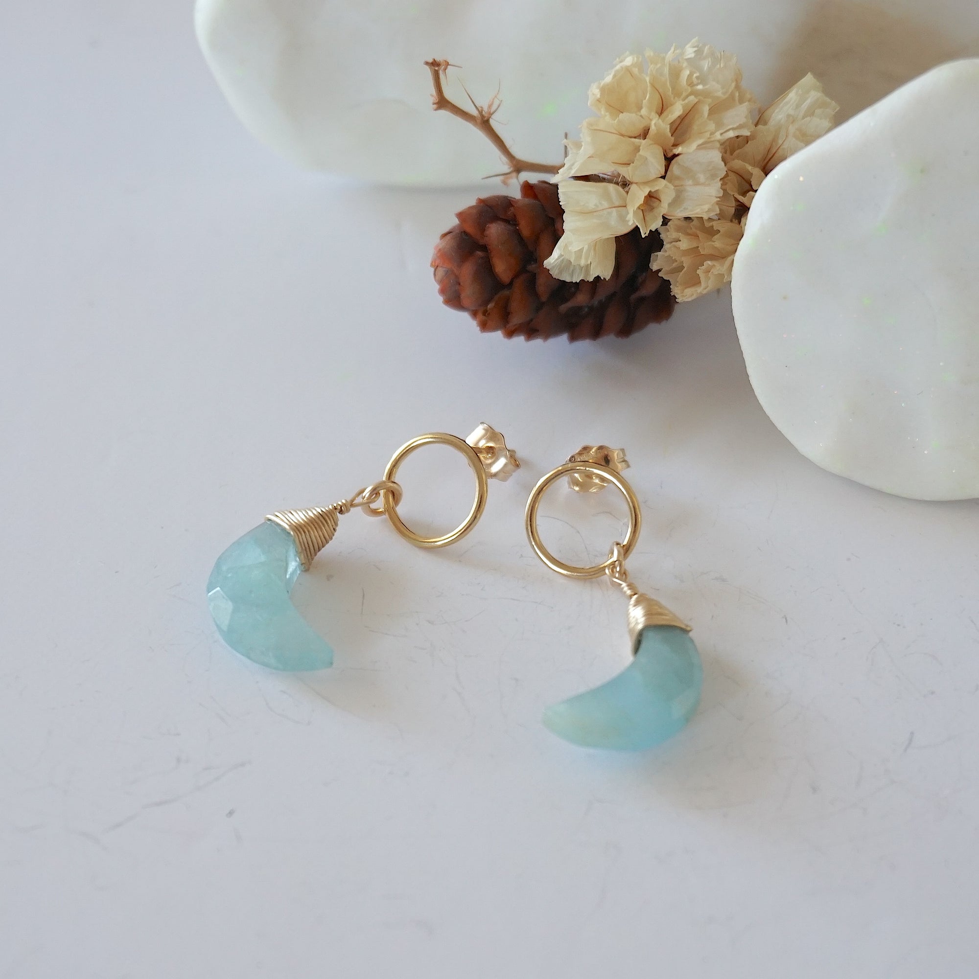 Aquamarine Moon Open Circle Stud Earrings laying flat, 14k gold filled minimalist wire wrap, natural faceted aquamarine, limited edition.