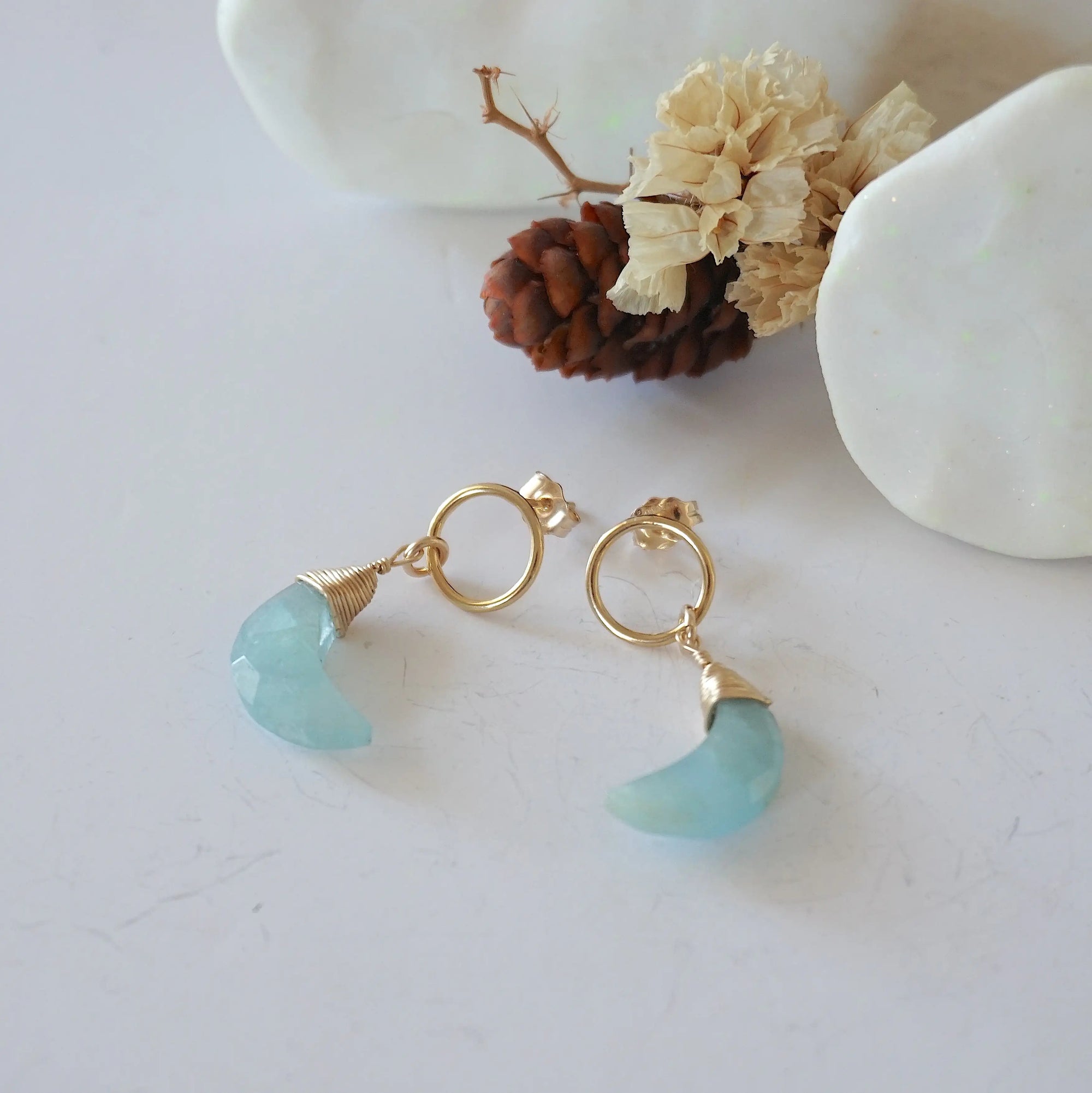 Aquamarine Moon Open Circle Stud Earrings laying flat, 14k gold filled minimalist wire wrap, natural faceted aquamarine, limited edition.