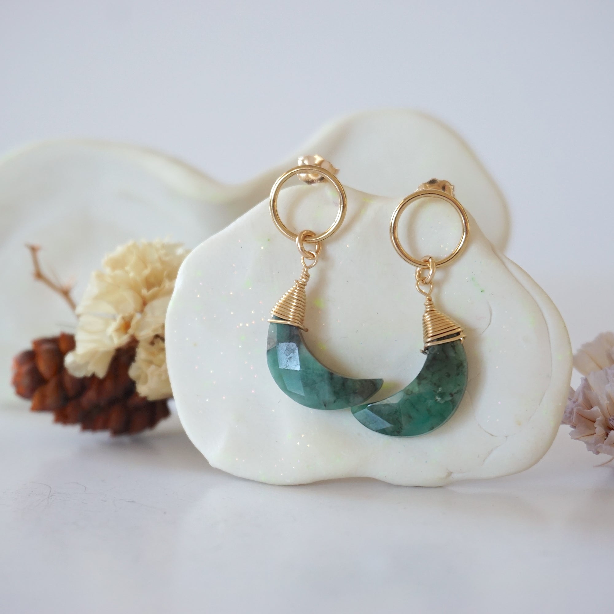 Detailed close-up of Lux Limited Edition Emerald Moon Open Circle Stud Earrings on jewelry display, faceted natural emerald, 14k gold filled, handmade.