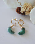Emerald Moon Open Circle Stud Earrings laying flat, 14k gold filled minimalist wire wrap, natural faceted emerald, limited edition.