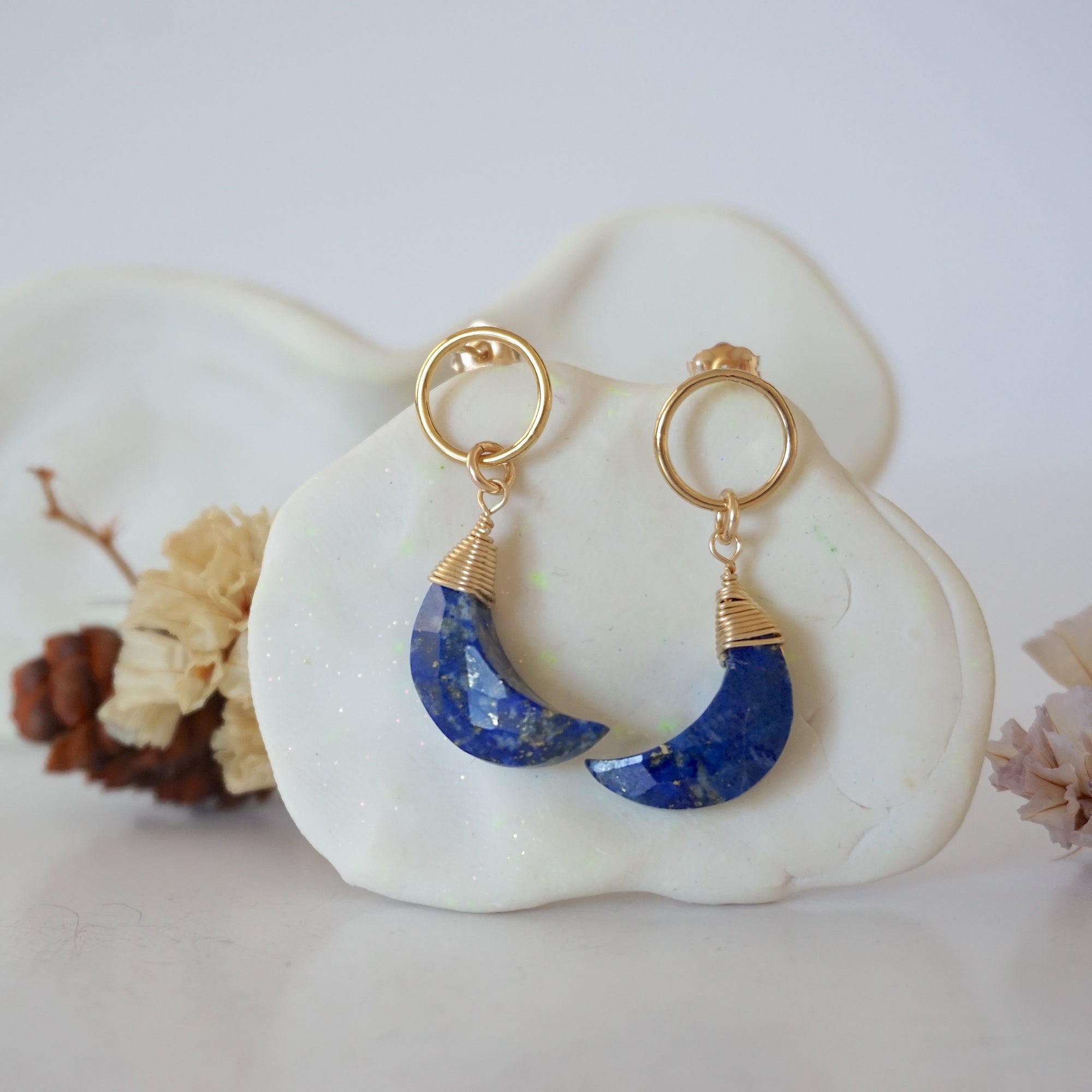 Detailed close-up of Lux Limited Edition Lapis Lazuli Moon Open Circle Stud Earrings on jewelry display, faceted natural lapis lazuli, 14k gold filled, handmade.