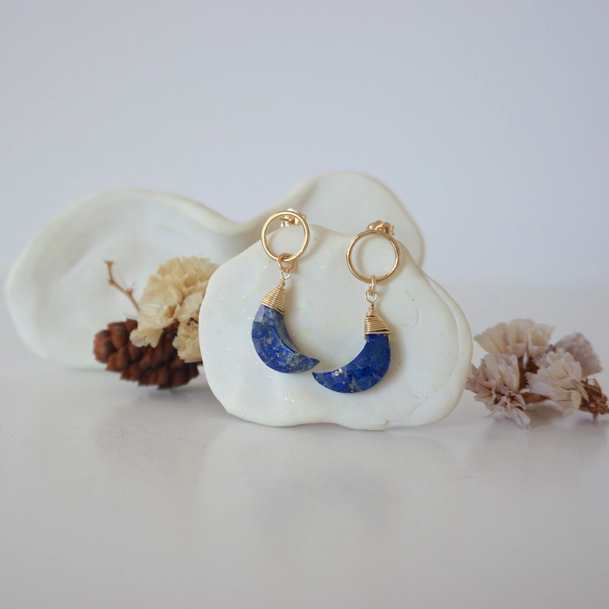 Front angle look at Lux Lapis Lazuli Moon Open Circle Stud Earrings on jewelry display, faceted natural lapis lazuli, gold filled, handmade.