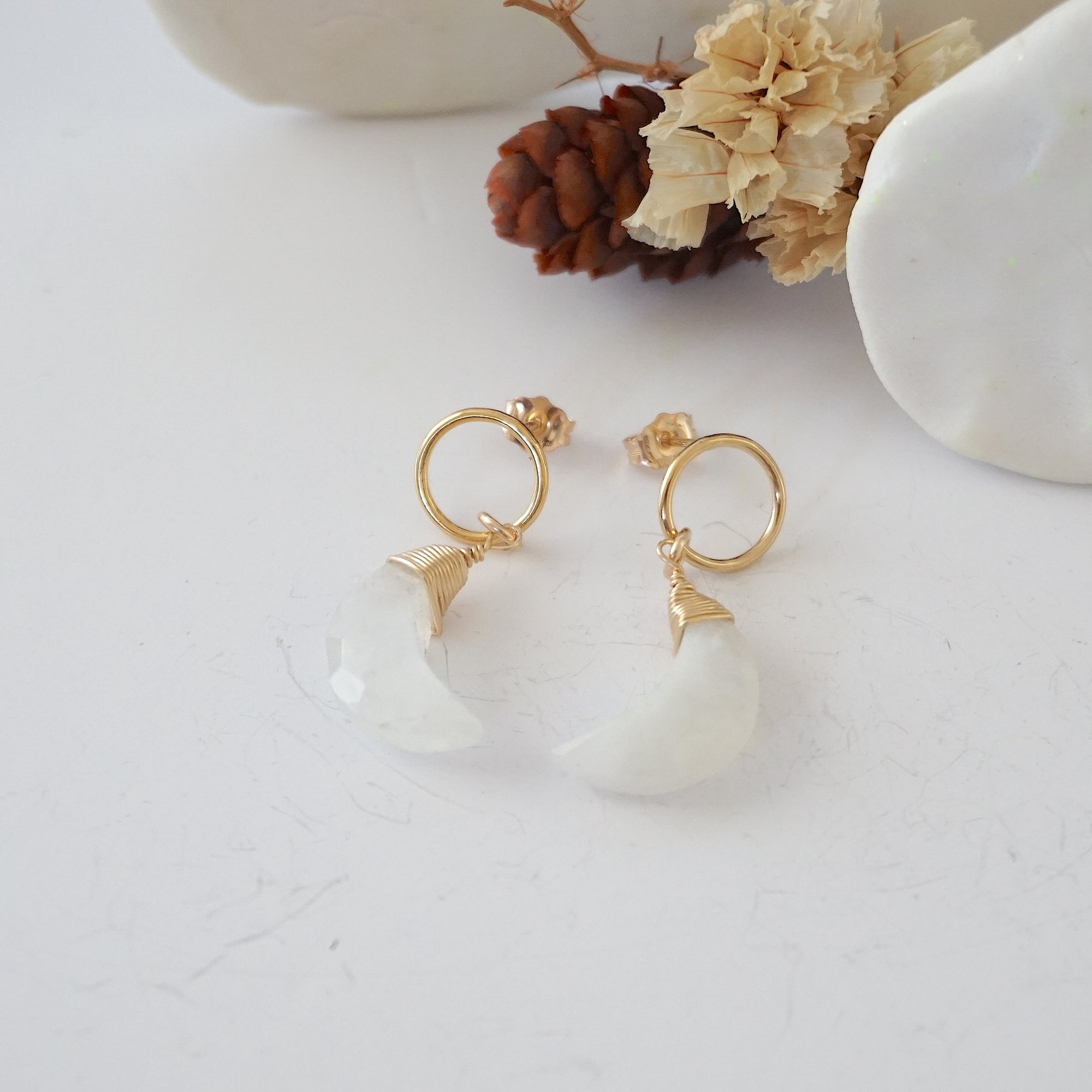 Rainbow Moonstone Moon Open Circle Stud Earrings laying flat, 14k gold filled minimalist wire wrap, natural faceted rainbow moonstone, limited edition.