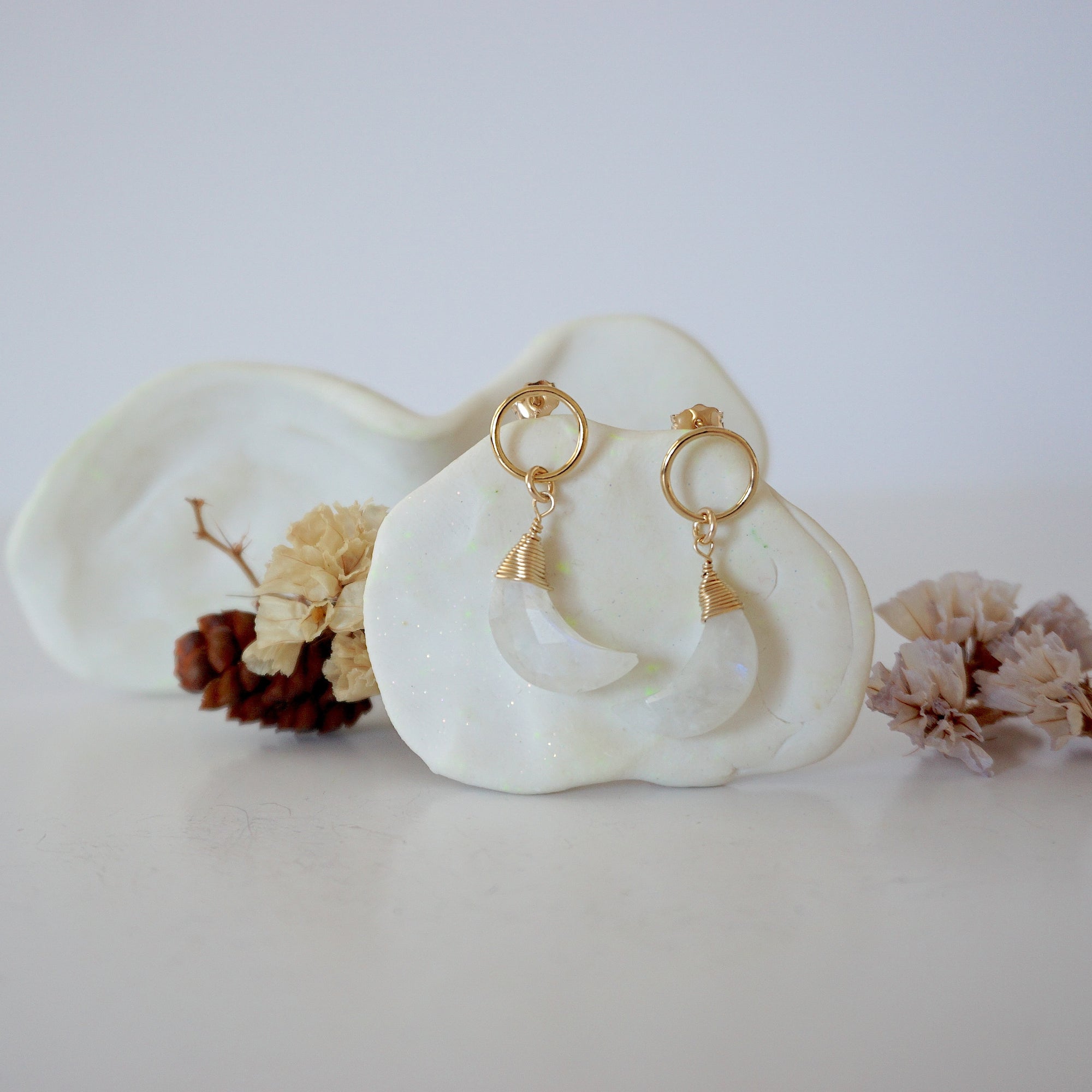 Front angle look at Lux Rainbow Moonstone Moon Open Circle Stud Earrings on jewelry display, faceted natural rainbow moonstone, gold filled, handmade.