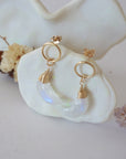 Side angle view of Rainbow Moonstone Moon Open Circle Stud Earrings hanging on jewelry display, minimalist 14k gold filled wire wrap, limited edition.