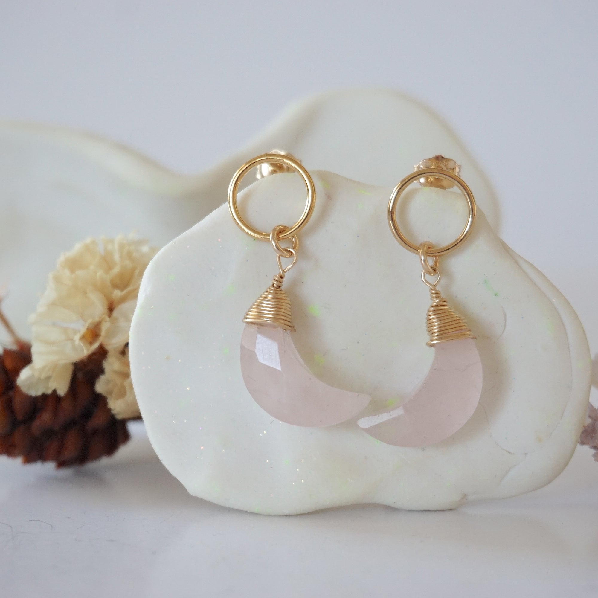 Detailed close-up of Lux Limited Edition Rose Quartz Moon Open Circle Stud Earrings on jewelry display, faceted natural rose quartz, 14k gold filled, handmade.