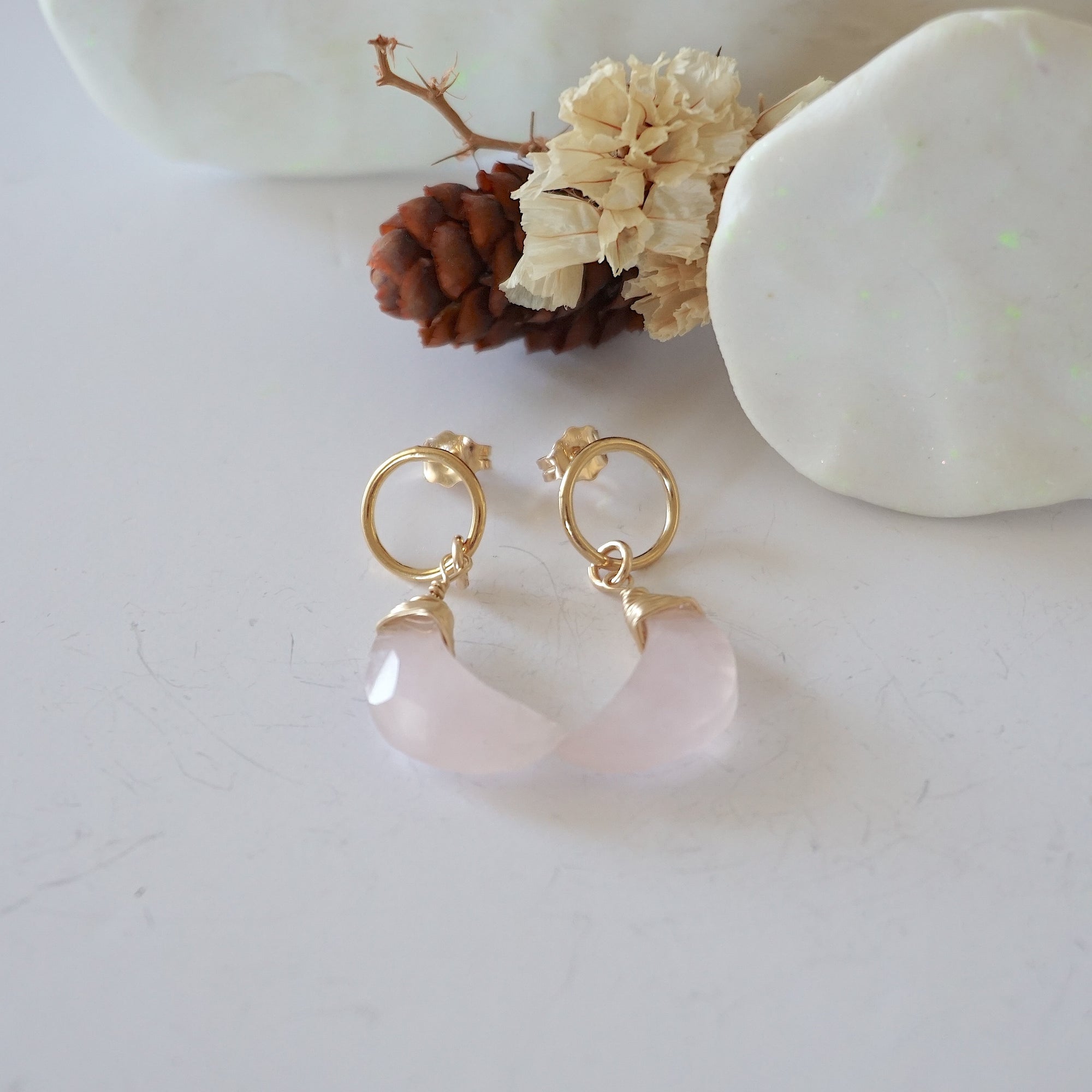 Rose Quartz Moon Open Circle Stud Earrings laying flat, 14k gold filled minimalist wire wrap, natural faceted rose quartz, limited edition.
