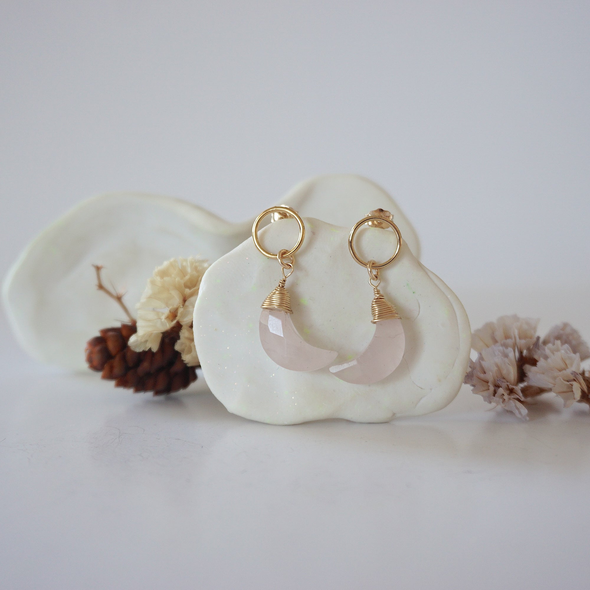 Front angle look at Lux Rose Quartz Moon Open Circle Stud Earrings on jewelry display, faceted natural rose quartz, gold filled, handmade.