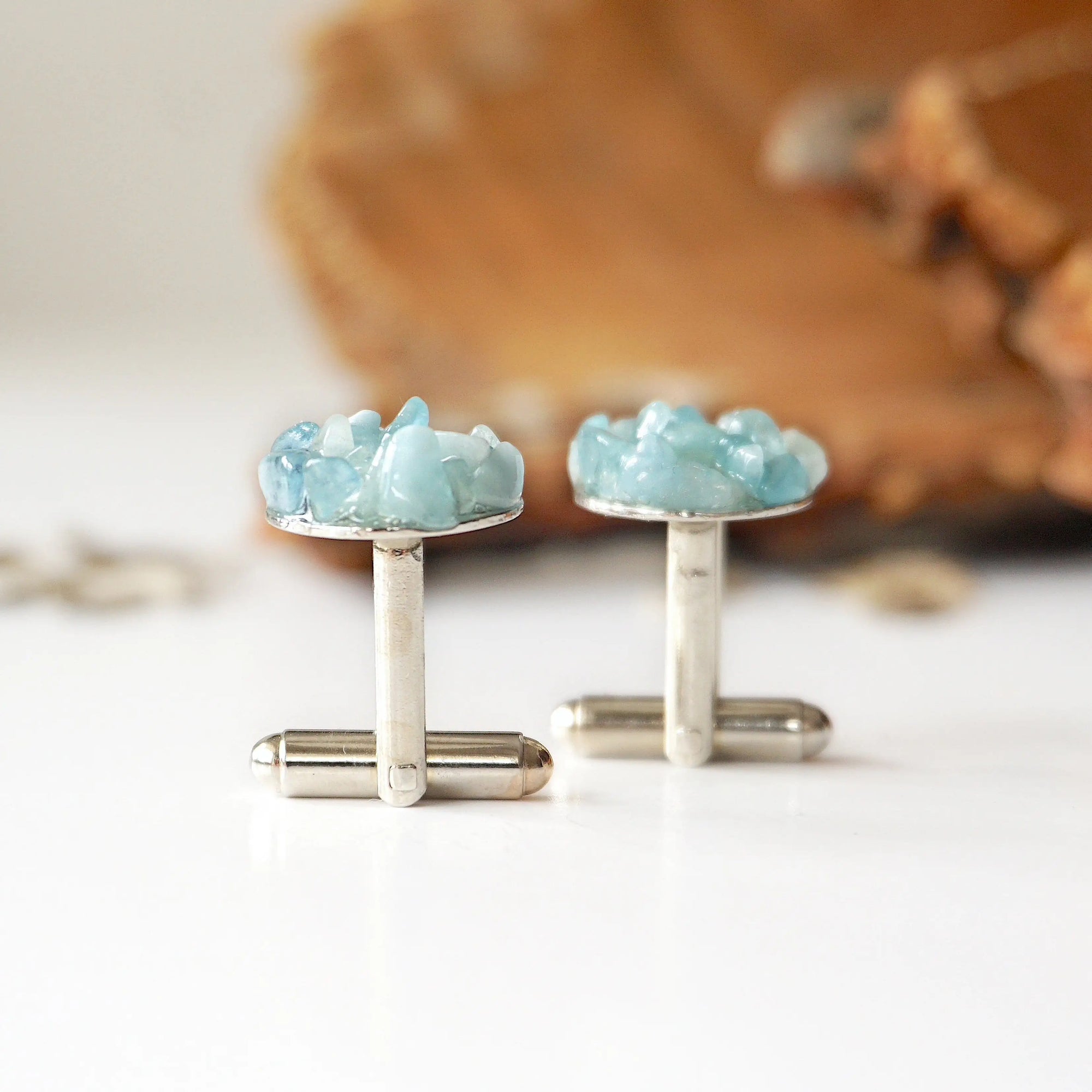 Back angle of men's aquamarine cufflinks, showing secure setting and resin finish, white gold finish copper