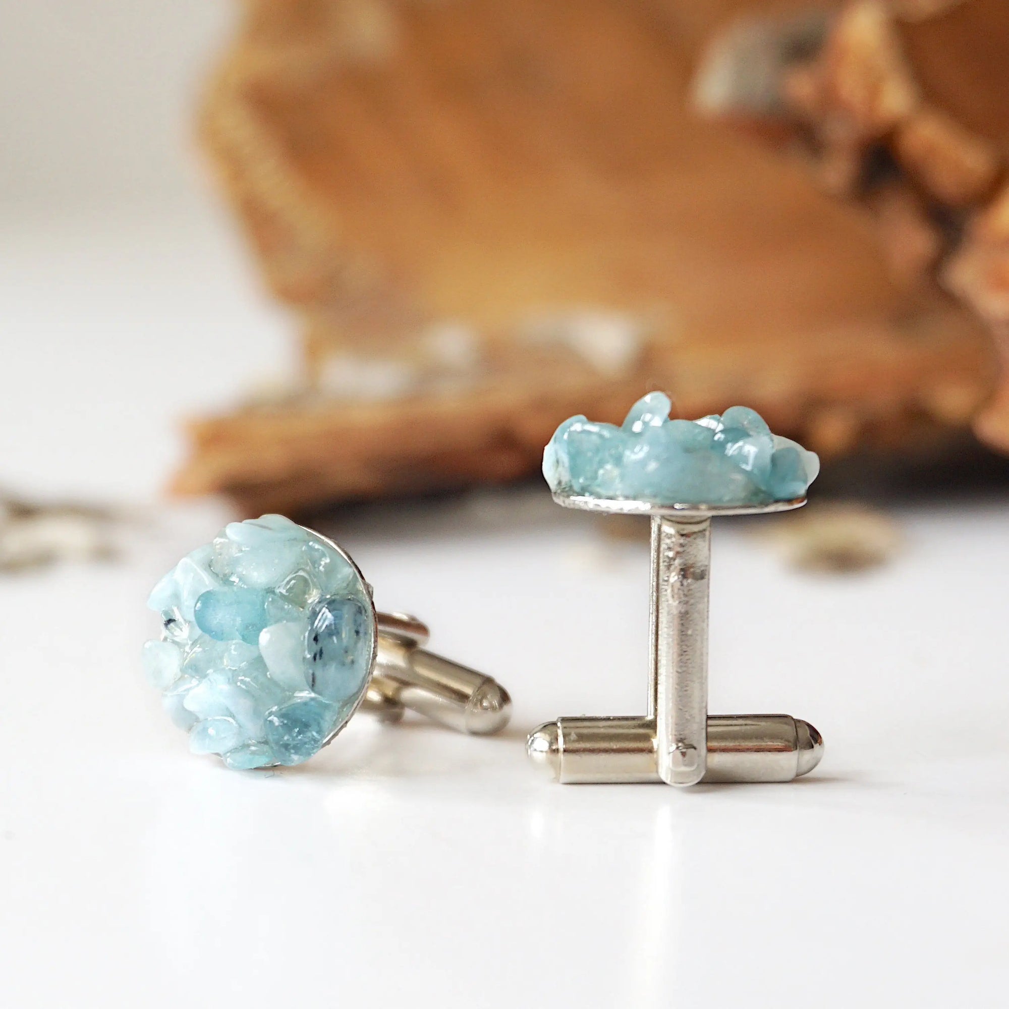 Right side angle of men's aquamarine cufflinks, showing genuine aquamarine stones, white gold finish copper