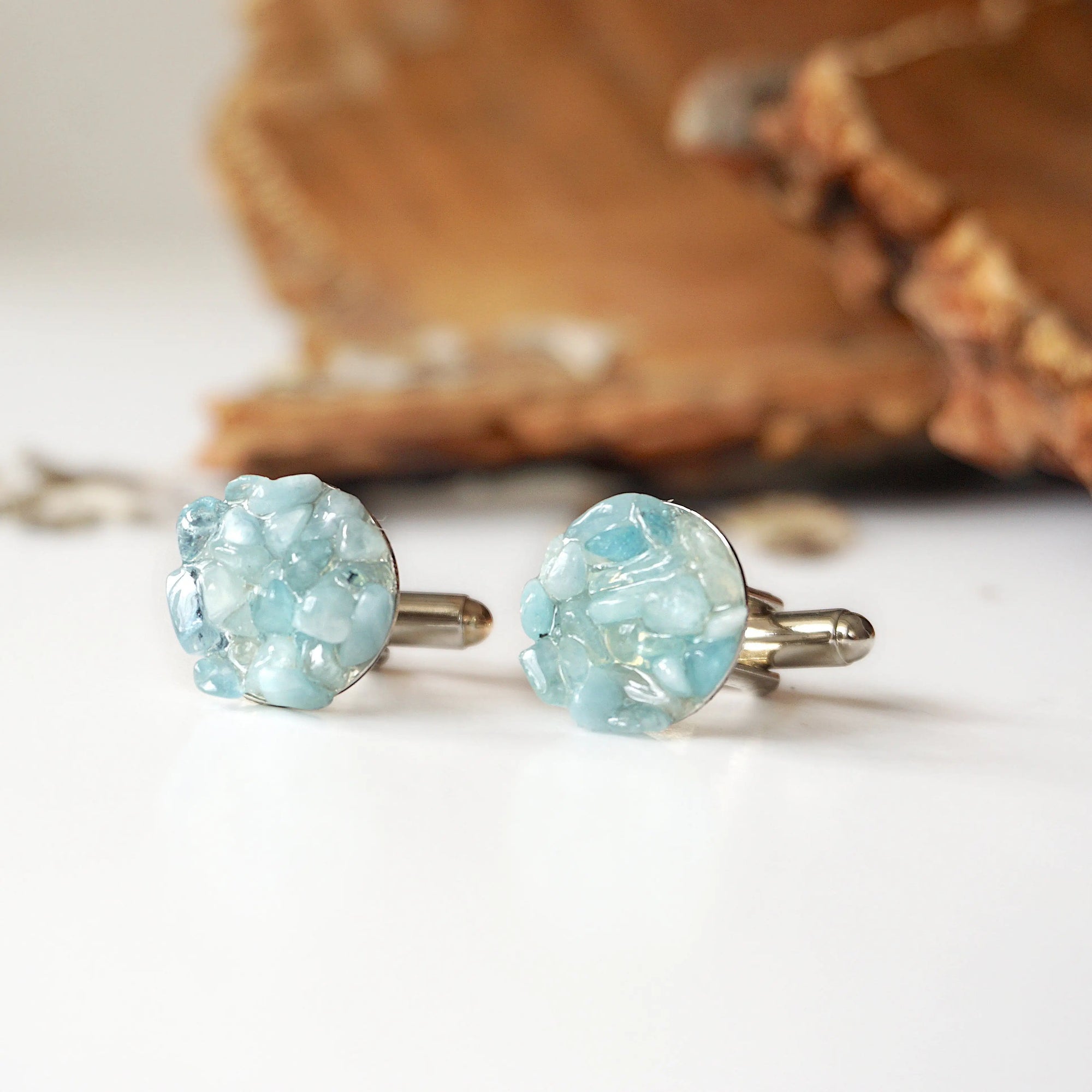 Top view of men's aquamarine cufflinks, multiple genuine aquamarine stones, white gold finish copper