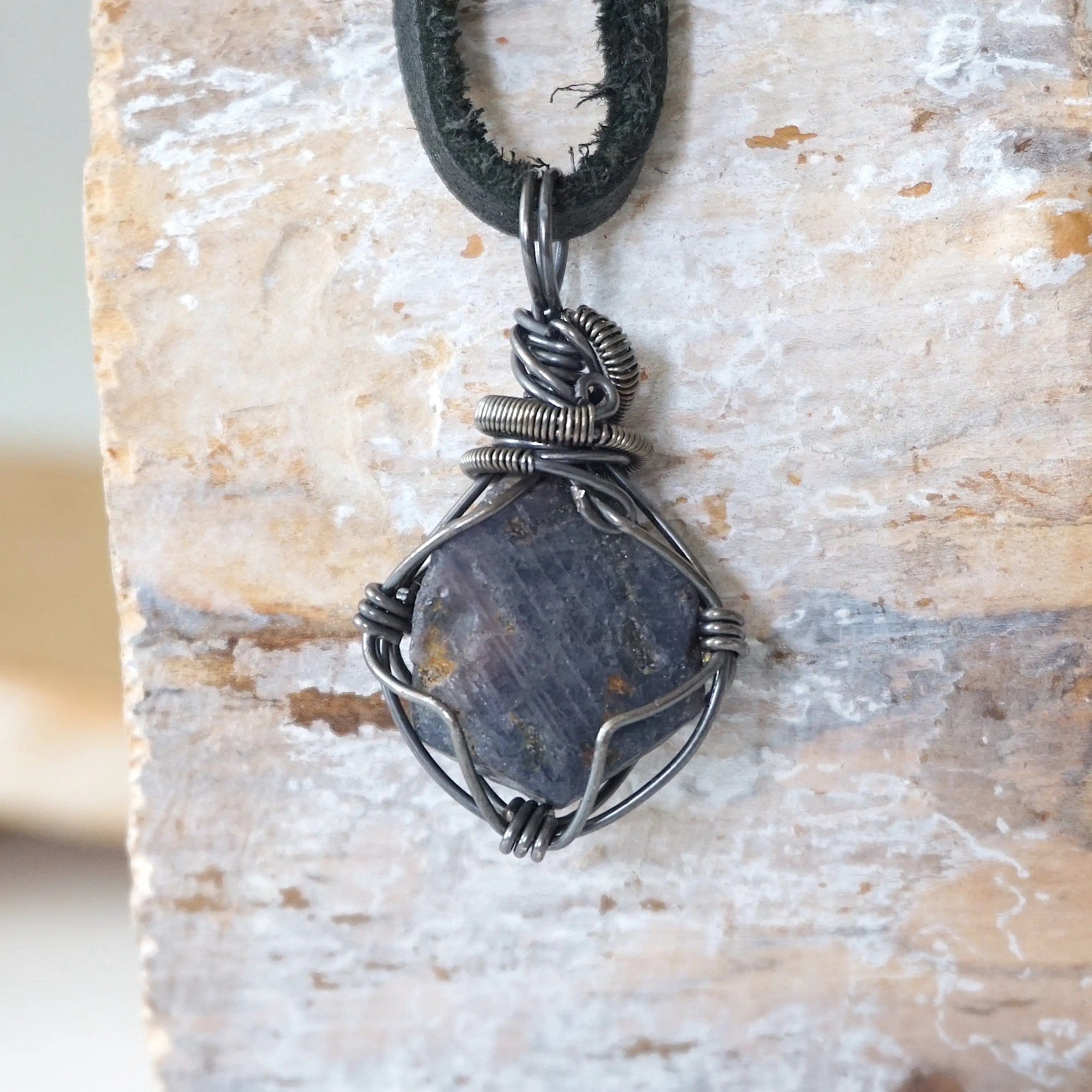 Back view of men's raw sapphire pendant showing the detail of antiqued 925 sterling silver wire-wrapping — one-of-a-kind handcrafted crystal jewelry
