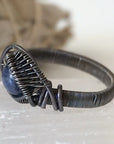 Side-angle detail of men's sapphire ring showing the artisan wire wrapping in antiqued 925 sterling silver