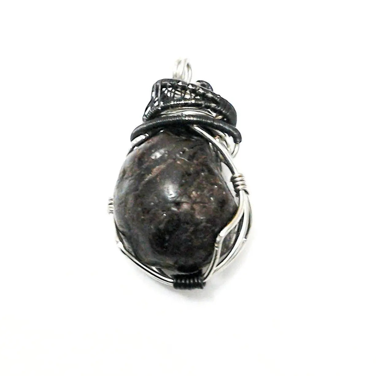 Close-up side view of a men’s wire wrapped garnet pendant highlighting the handcrafted mixed metal copper wire detail