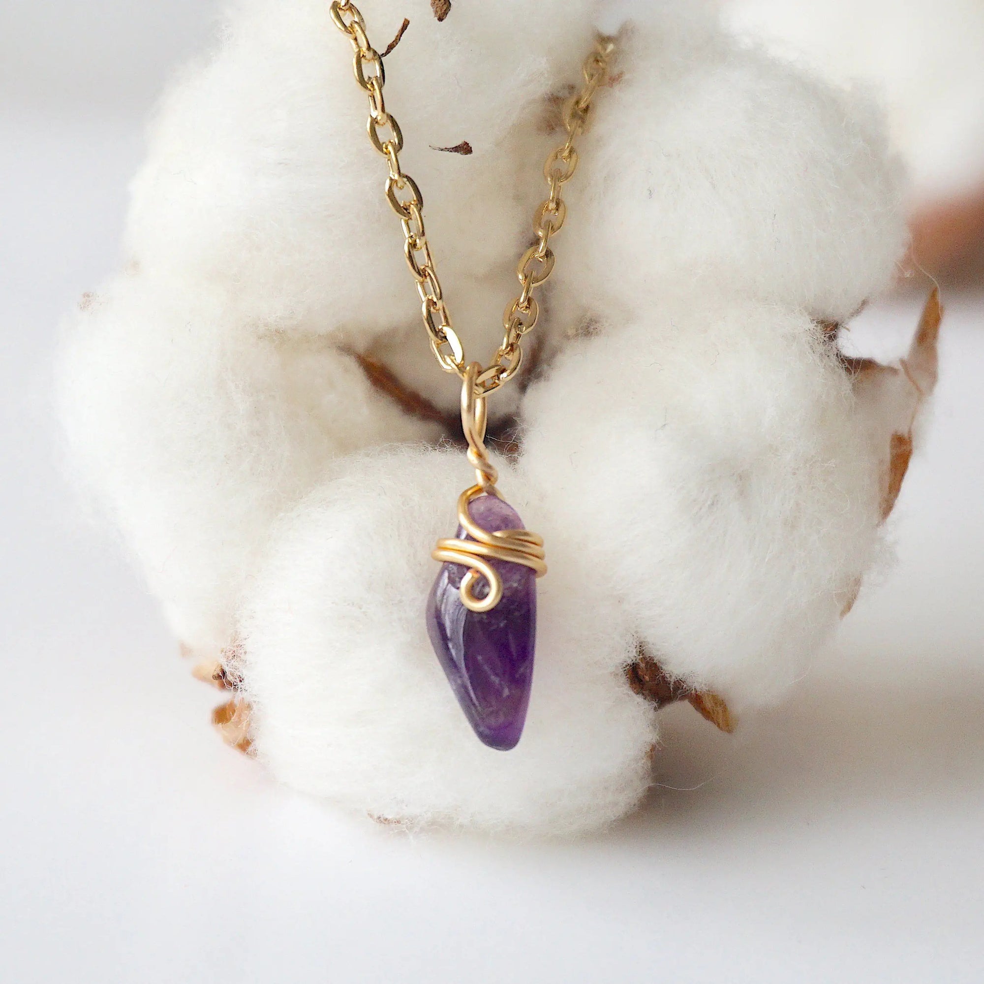 Back side angle of minimalist amethyst necklace, gold plated copper wire wrapped raw amethyst pendant