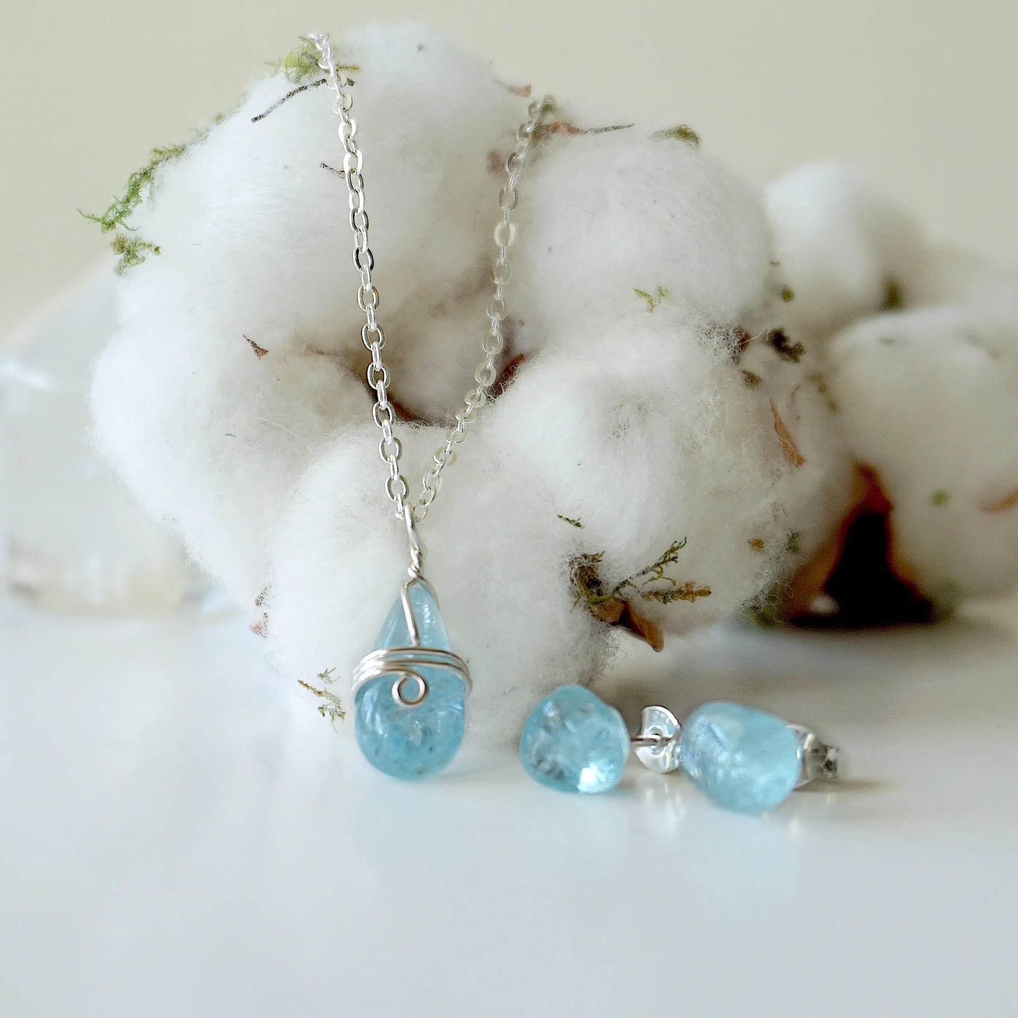 Detailed look at minimalist aquamarine necklace and stud earrings, genuine aquamarine, soft silver and sterling silver settings, artisan handcrafted