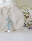 Right side angle of minimalist aquamarine necklace, showing genuine aquamarine pendant and soft silver finish over copper wire
