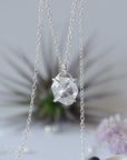 Detailed front view of minimalist Herkimer diamond necklace in 925 sterling silver with natural raw crystal pendant.