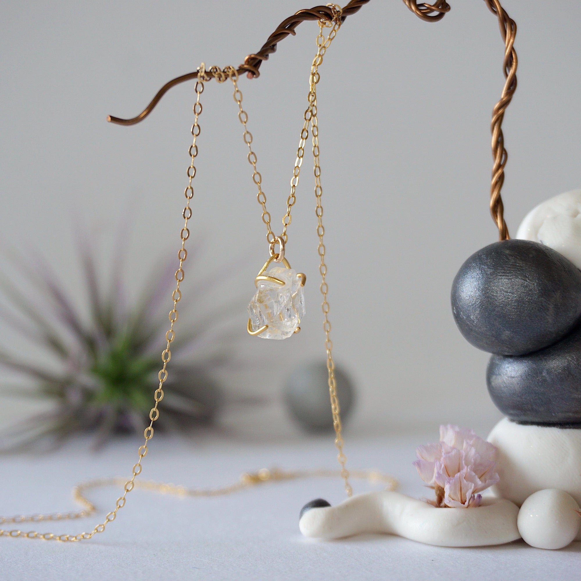 Side angle view of minimalist Herkimer diamond necklace showing gold vermeil prong setting detail.