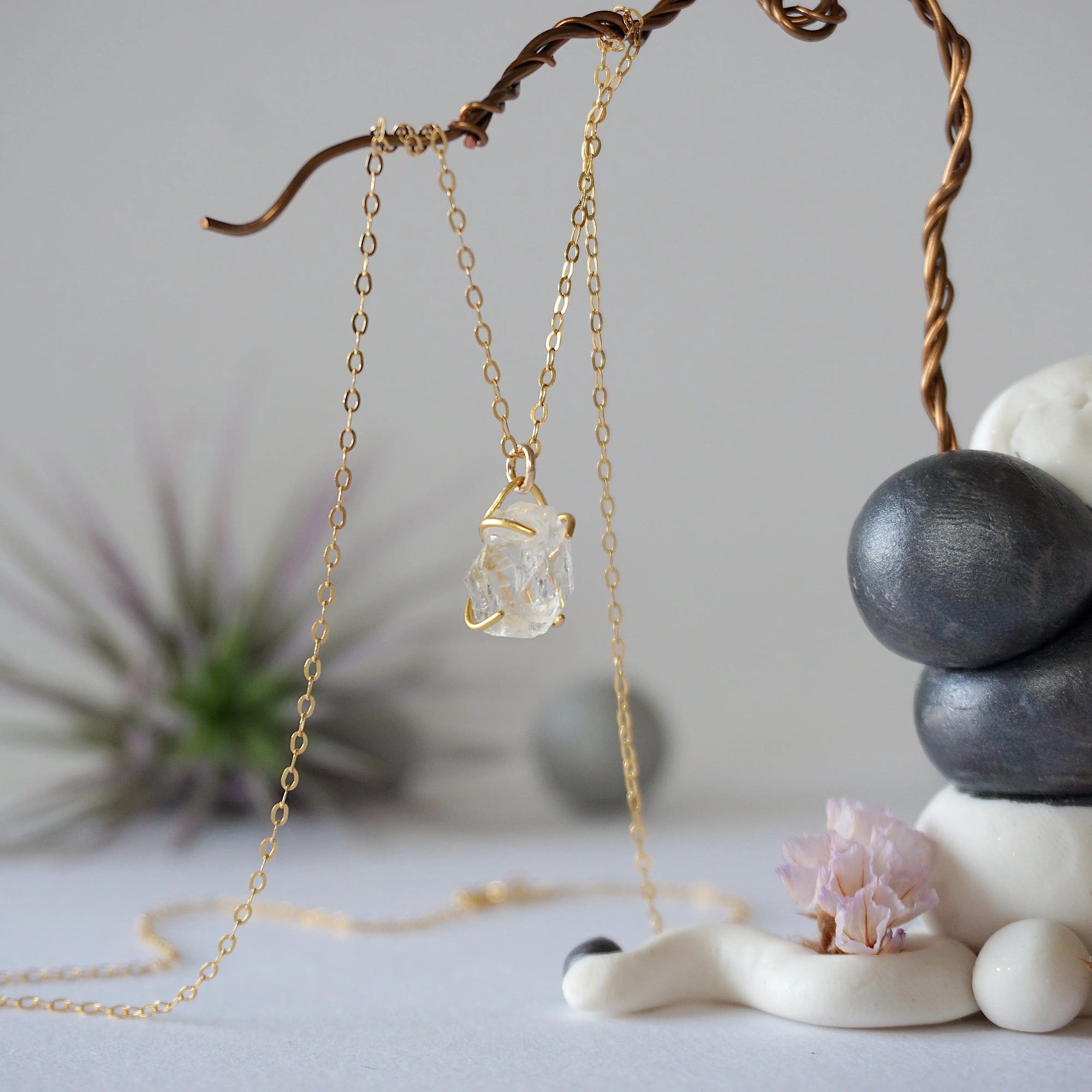 Side angle view of minimalist Herkimer diamond necklace showing gold vermeil prong setting detail.