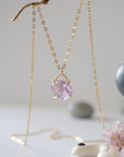 Front view of minimalist raw amethyst necklace in 14k gold vermeil claw setting on 14k gold filled chain, February birthstone