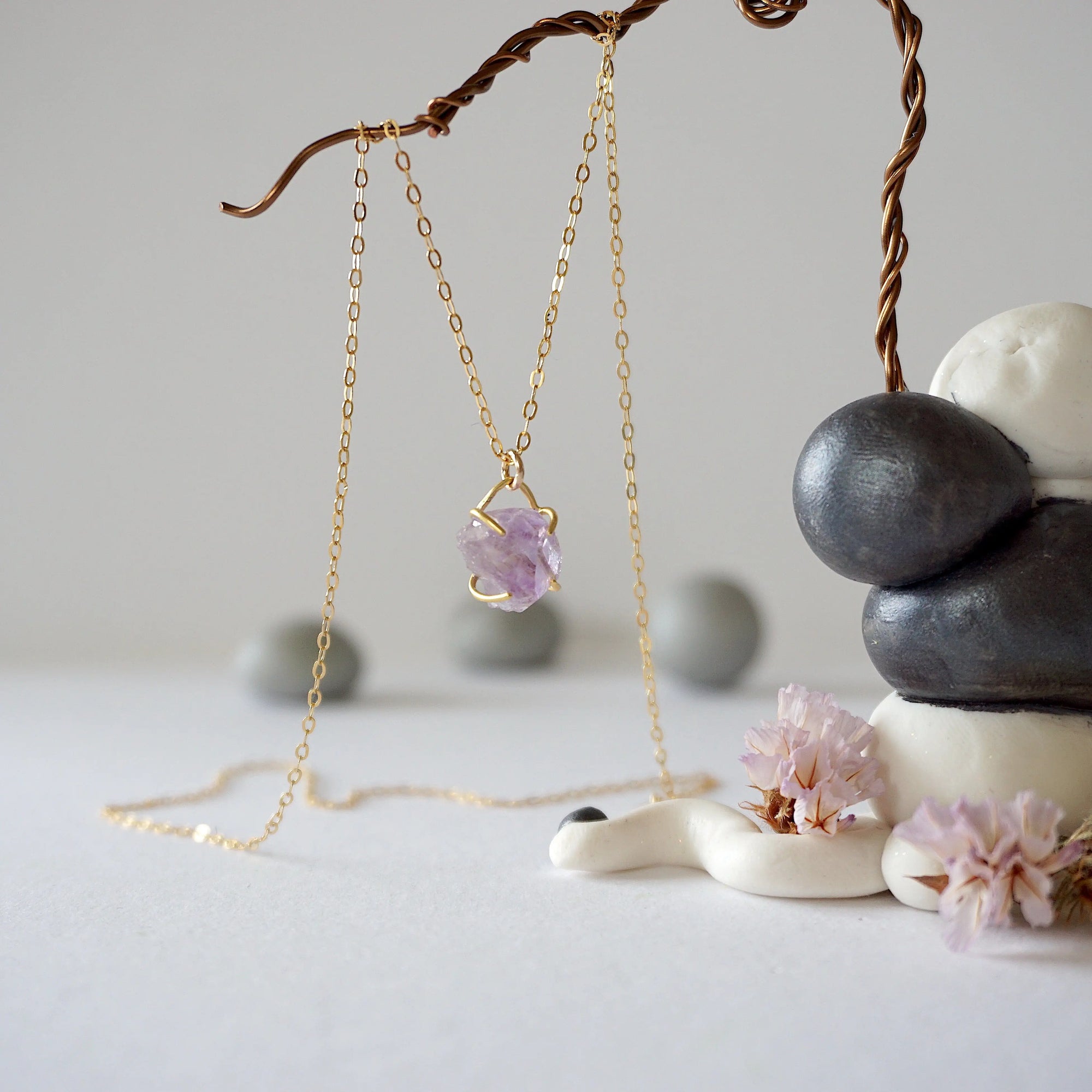 Side view of raw amethyst crystal pendant necklace in 14k gold vermeil claw setting on 14k gold filled cable chain