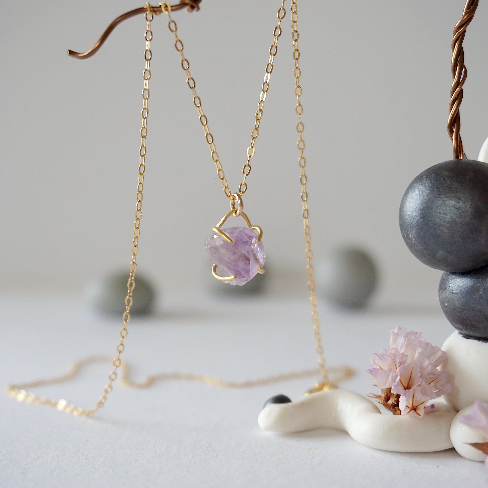 Side angle detail of minimalist raw amethyst necklace in gold vermeil, natural unpolished amethyst stone pendant