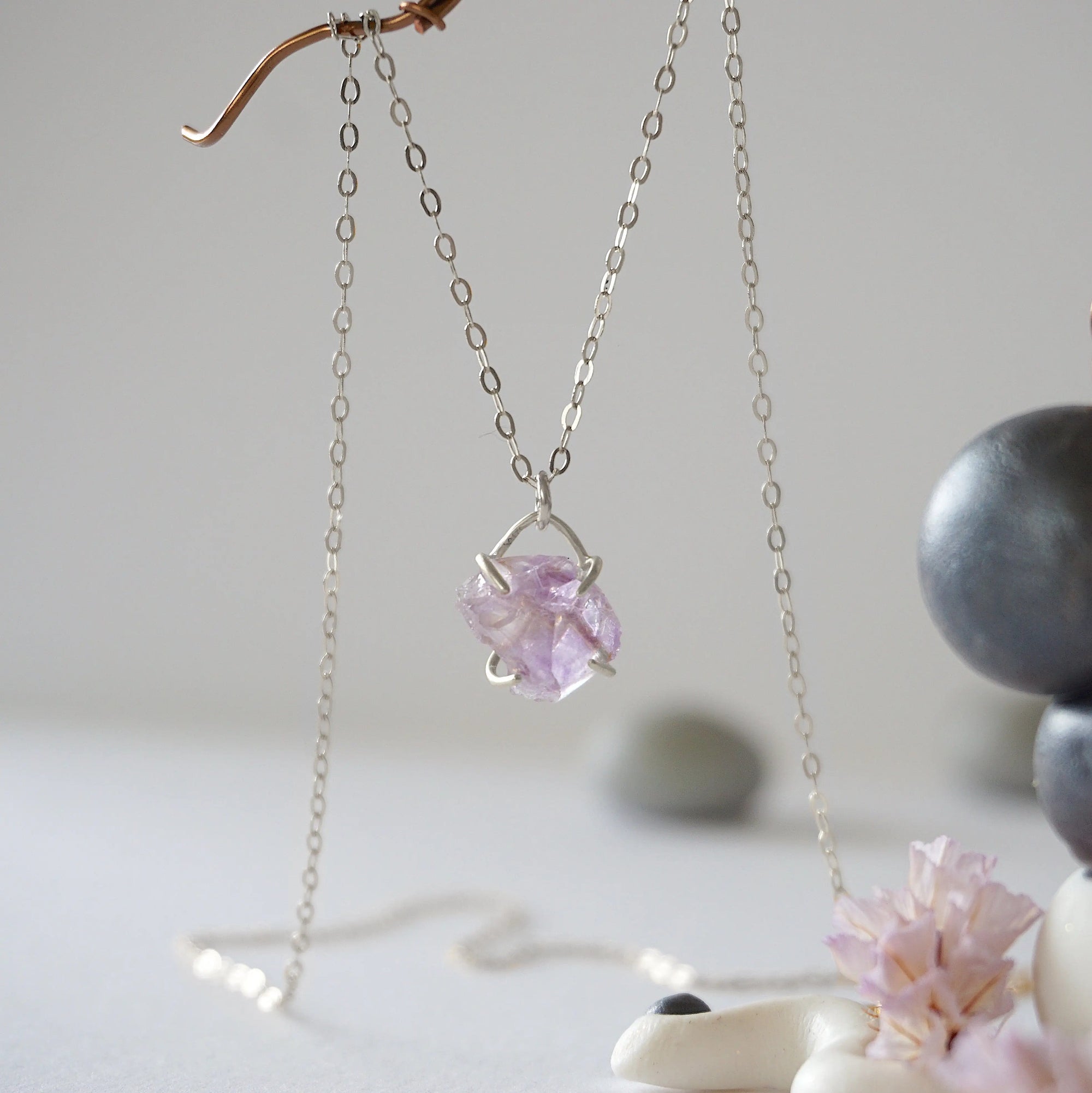 Front view of minimalist raw amethyst necklace in 925 sterling silver claw setting, February birthstone crystal pendant