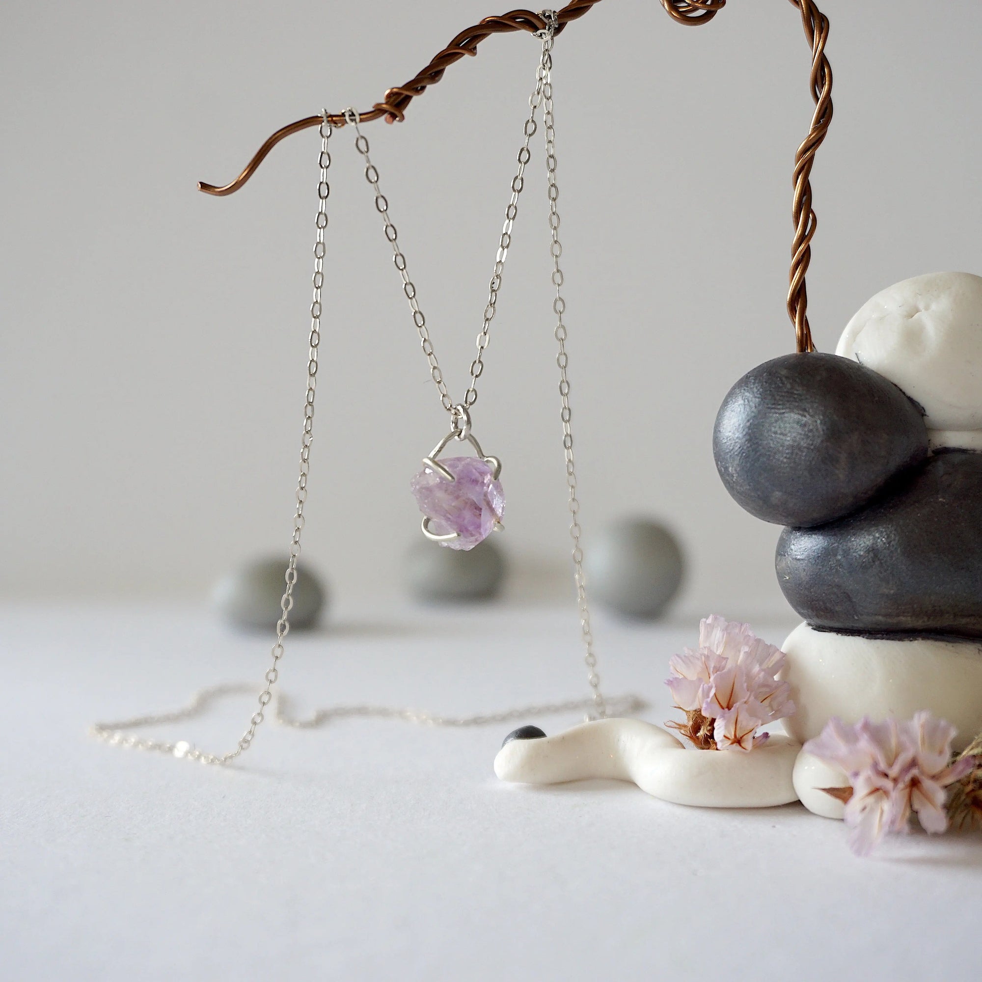 Side angle detail of minimalist raw amethyst necklace in sterling silver, natural unpolished amethyst stone pendant